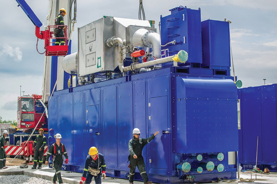 Each module is completely self-contained in an 8-ft. x 40-ft. sound attenuated enclosure. A gas-fired engine-compressor set produces compressed air that is added to the combustion turbine’s compressor discharge section to reduce the effect of a high ambient temperature or altitude performance derate. Photo Courtesy: Powerphase